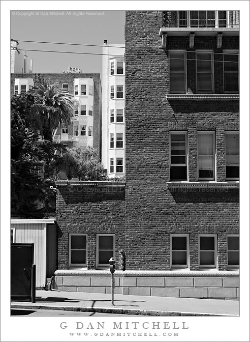 Sidewalk, Brick Building, Hotel Sign