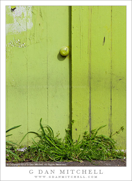 Door Knob, Green Wall, and Grass - A worn green wall with doorknob, grass along the street, Fremont District, Seattle, Washington