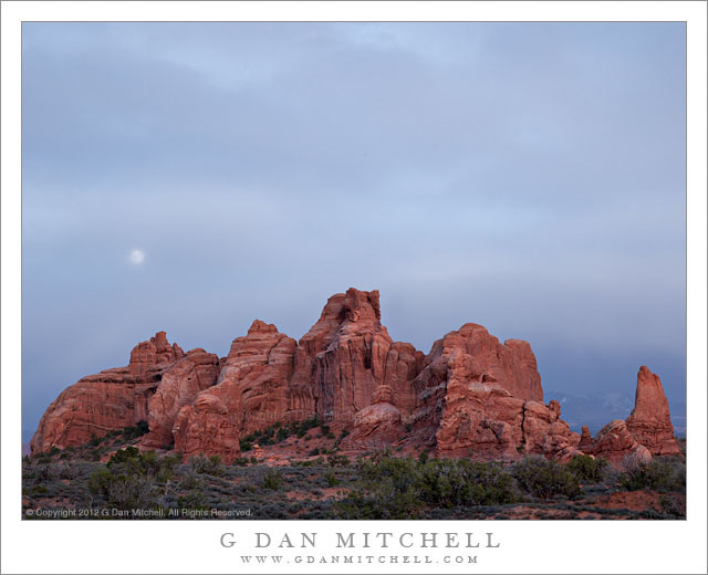 Moonrise, Clouds, and Sandstone Towers - The full moon rises through thin clouds above sandstone towers, Arches National Park.