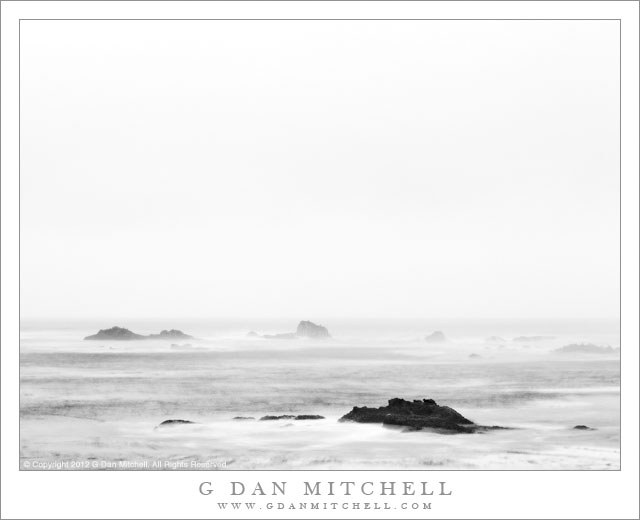 Rocks and Surf, Point Lobos - Long exposure black and white photograph of offshore rocks, surf, and fog at the Point Lobos State Reserve, California