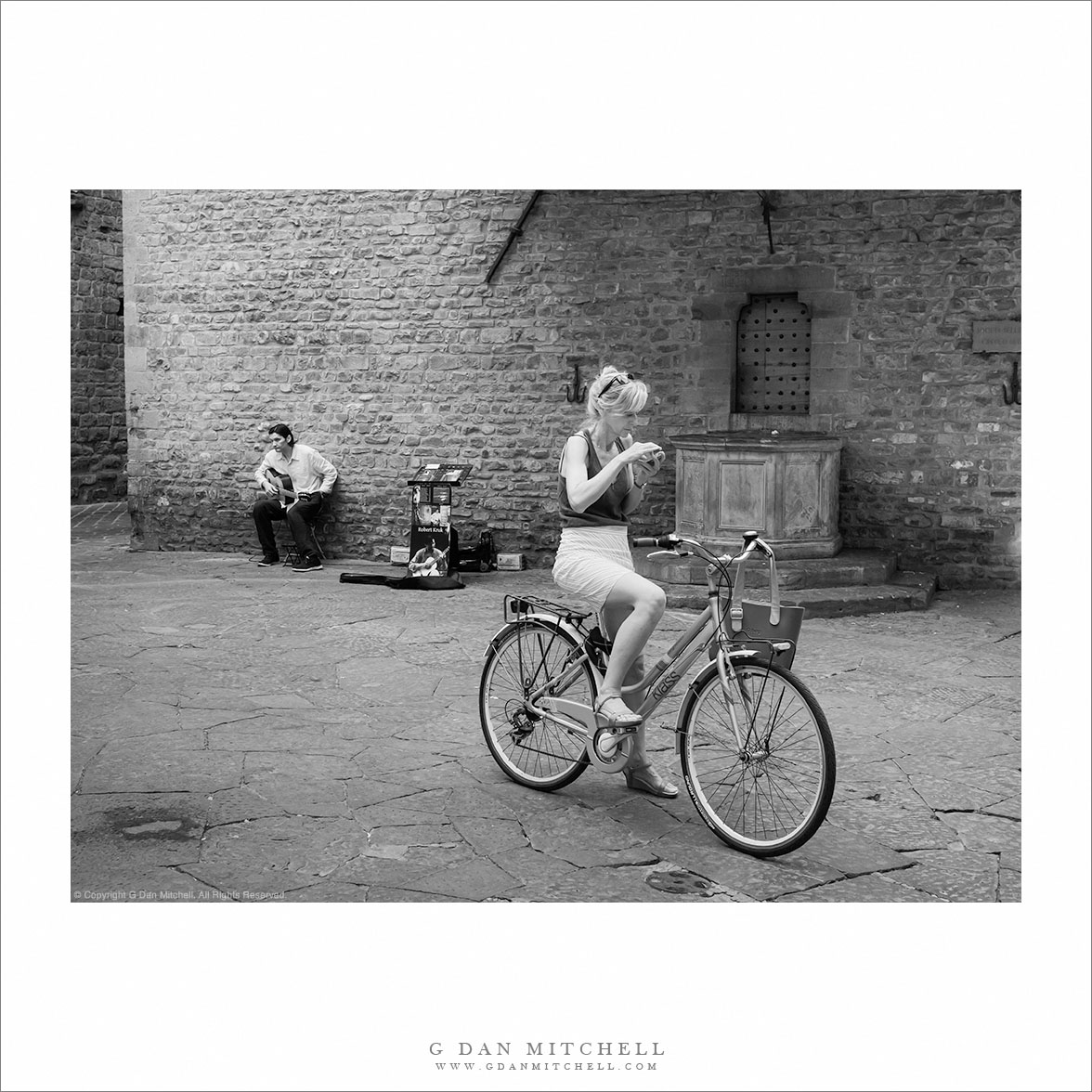 Woman On Bicycle, Street Musician